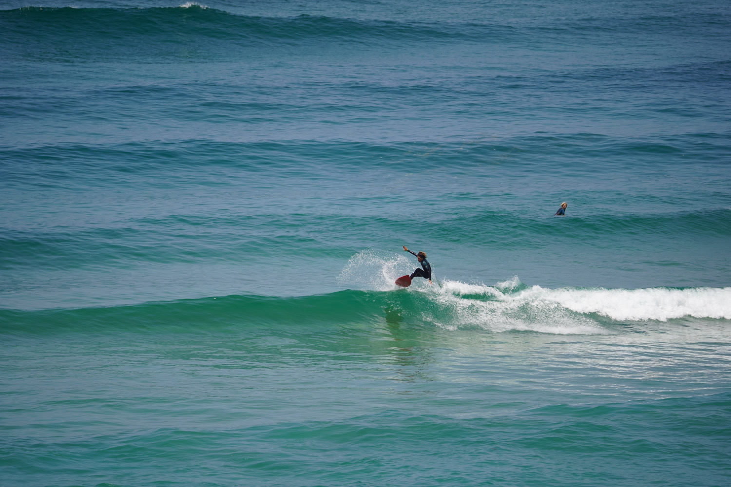 Empty beach and surfer